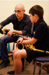 Michael Hudson-Casanova teaching a student a saxophone lesson